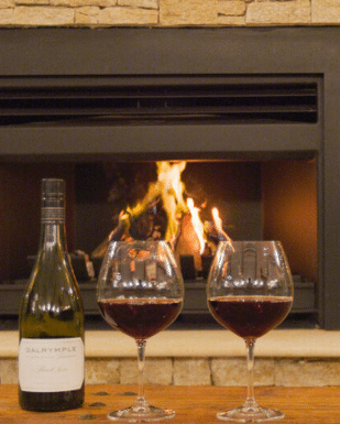 Red wine in front of fire at Hazelwood Estate