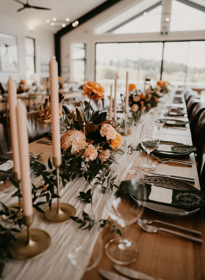 Modern farmhouse style wedding table setting with peach toned blooms
