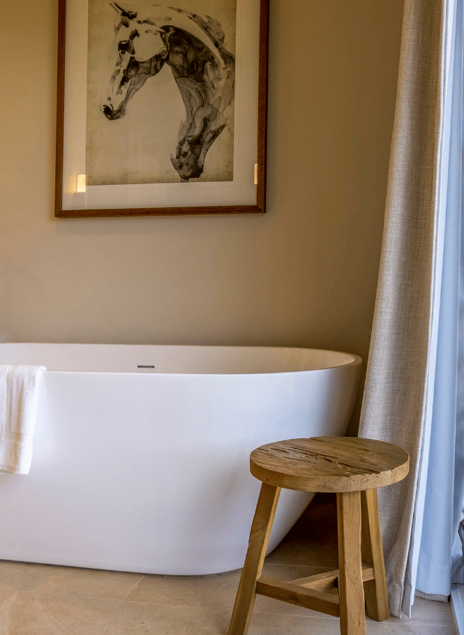 Freestanding bath, timber stool and horse painting in Pavilion ensuite